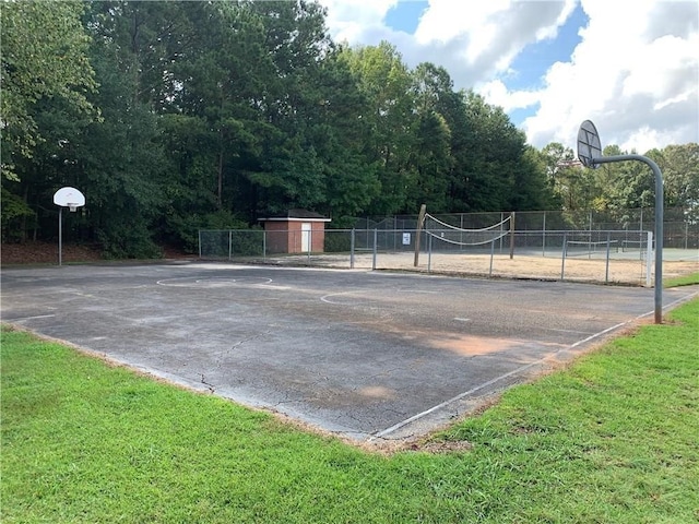 view of sport court featuring community basketball court, a yard, and fence