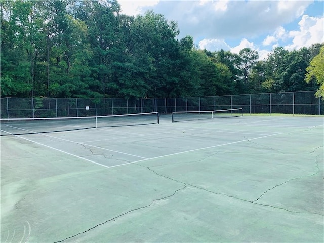 view of sport court featuring fence