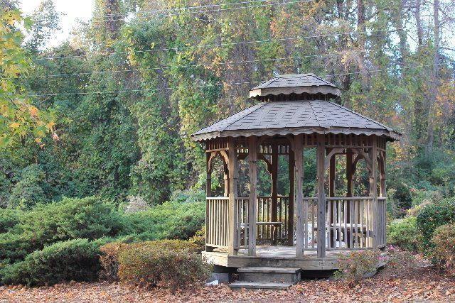 exterior space featuring a gazebo and a wooded view