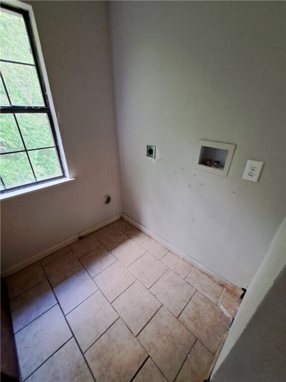 2106 Auburn St, Tuskegee, AL 36083 - clothes washing area featuring baseboards, light tile patterned floors, hookup for a washing machine, hookup for an electric dryer, and laundry area