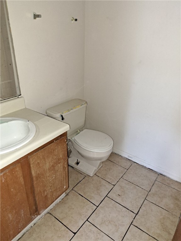 2106 Auburn St, Tuskegee, AL 36083 - half bath with vanity, toilet, and tile patterned floors