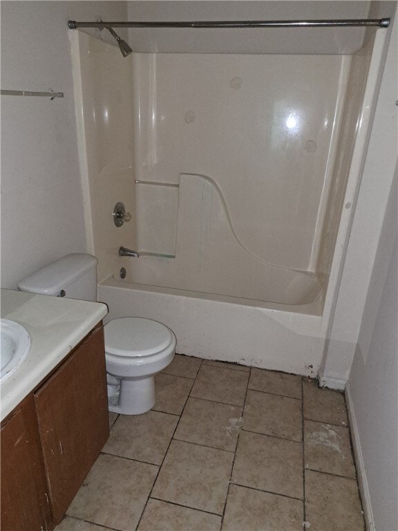 2106 Auburn St, Tuskegee, AL 36083 - full bath with toilet, shower / tub combination, vanity, tile patterned floors, and baseboards