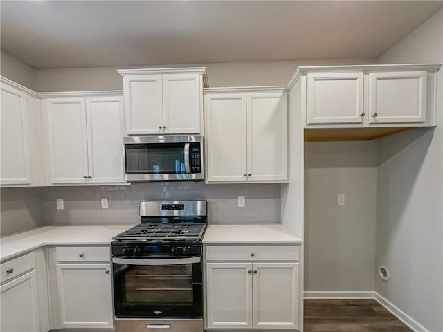 kitchen with appliances with stainless steel finishes, light countertops, white cabinetry, and tasteful backsplash