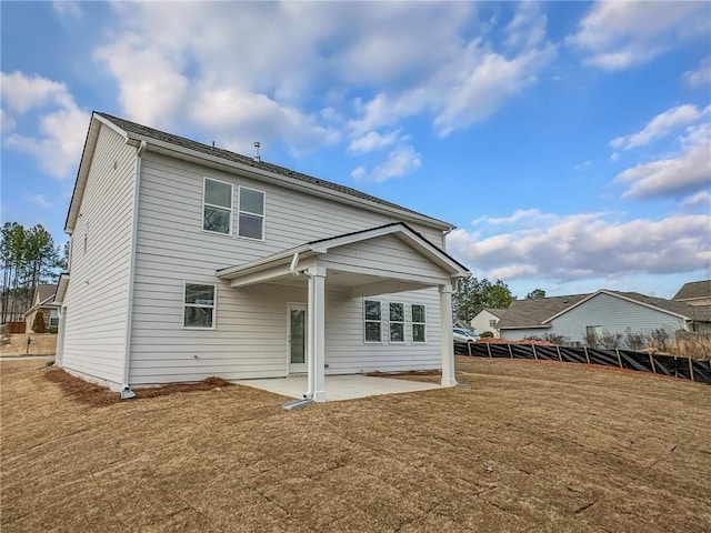 back of house with a patio, a lawn, and fence