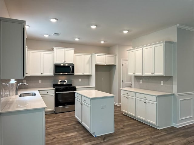 2113 Covey Dr, Auburn, AL 36879 - kitchen featuring stainless steel appliances, a sink, backsplash, dark wood-style flooring, and recessed lighting
