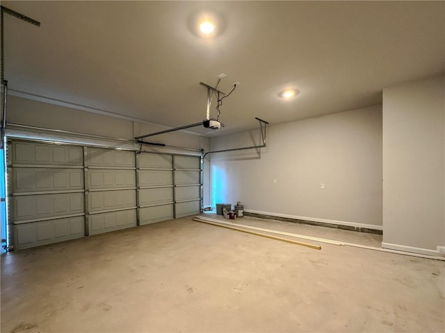 garage with baseboards and a garage door opener