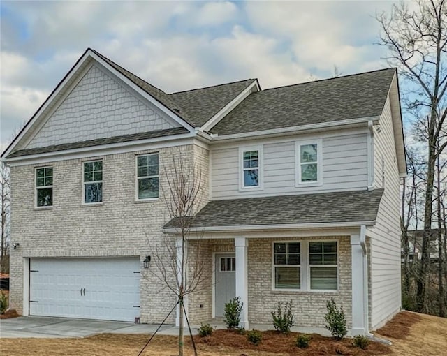 craftsman inspired home with a garage, brick siding, driveway, and a shingled roof