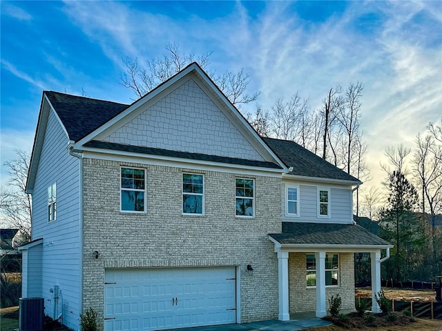 view of front facade featuring a garage, central AC, and covered porch