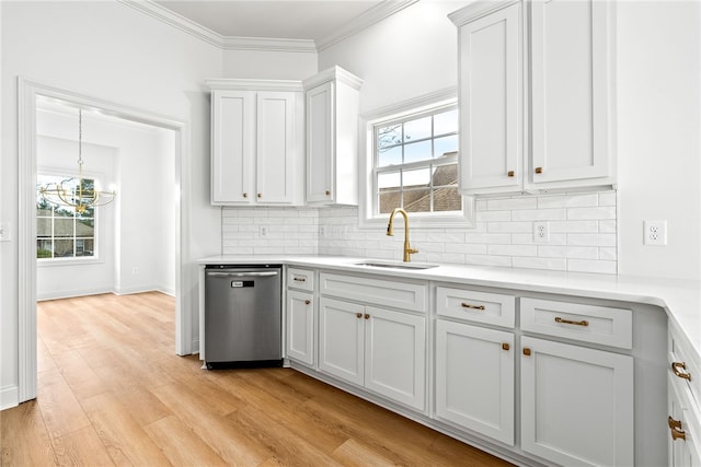1756 Vfw Rd, Auburn, AL 36832 - kitchen featuring dishwasher, decorative backsplash, light wood-style floors, light countertops, and ornamental molding