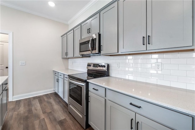 564 Grey Oak Cir, Auburn, AL 36830 - kitchen with stainless steel appliances, gray cabinetry, crown molding, dark wood-type flooring, and light stone countertops