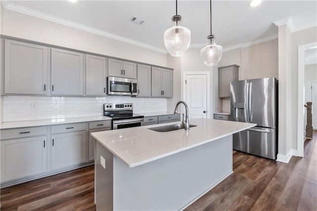 564 Grey Oak Cir, Auburn, AL 36830 - kitchen with appliances with stainless steel finishes, gray cabinets, ornamental molding, dark wood-style floors, and backsplash