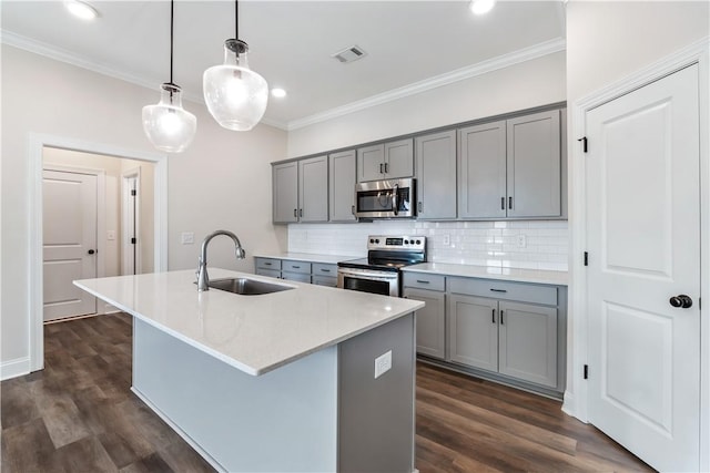 564 Grey Oak Cir, Auburn, AL 36830 - kitchen with stainless steel appliances, gray cabinetry, backsplash, ornamental molding, and a kitchen island with sink