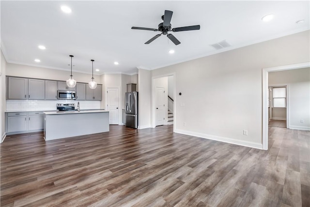 564 Grey Oak Cir, Auburn, AL 36830 - unfurnished living room with ornamental molding, recessed lighting, stairs, ceiling fan, and dark wood-style flooring