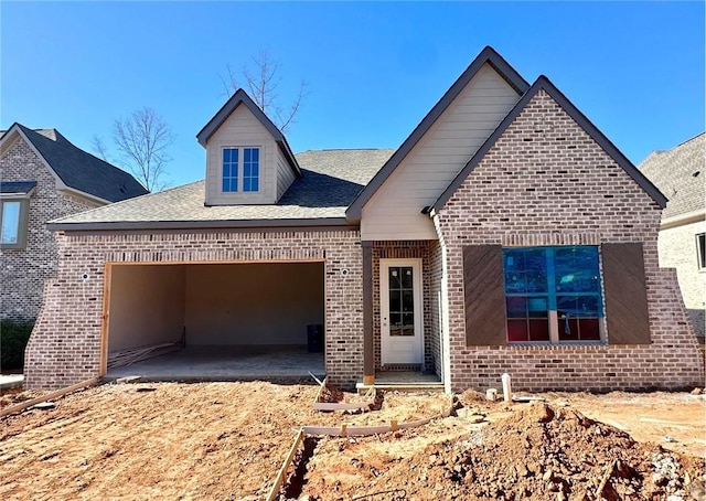 view of front of house with brick siding and an attached garage