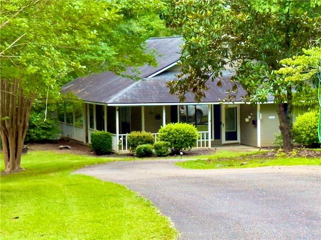 5755 Lee Road 390, Opelika, AL 36804 - view of front of home featuring covered porch, roof with shingles, a front yard, and driveway