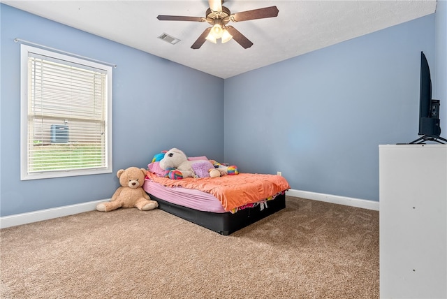 bedroom featuring carpet, baseboards, multiple windows, and ceiling fan