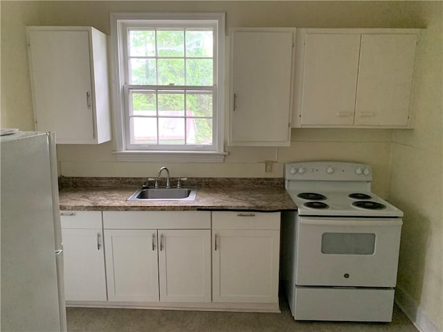 336 Payne St, Auburn, AL 36830 - kitchen featuring white appliances, a sink, white cabinetry, and dark countertops