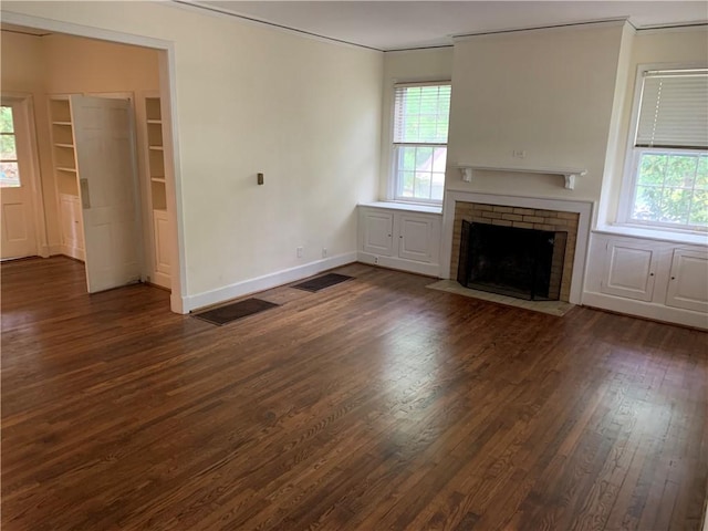 336 Payne St, Auburn, AL 36830 - unfurnished living room featuring crown molding, dark wood-type flooring, healthy amount of natural light, a fireplace, and baseboards