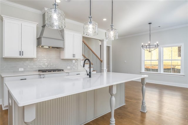 kitchen featuring white cabinets, a spacious island, and sink