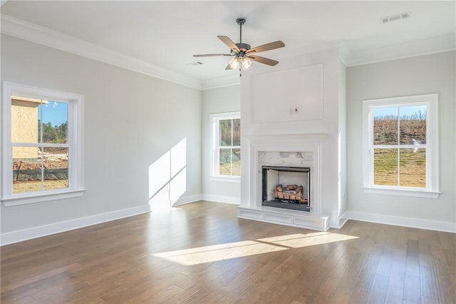 unfurnished living room with ceiling fan, hardwood / wood-style floors, and crown molding