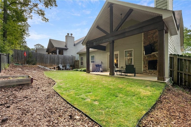 back of house with stone siding, a vegetable garden, and a fenced backyard