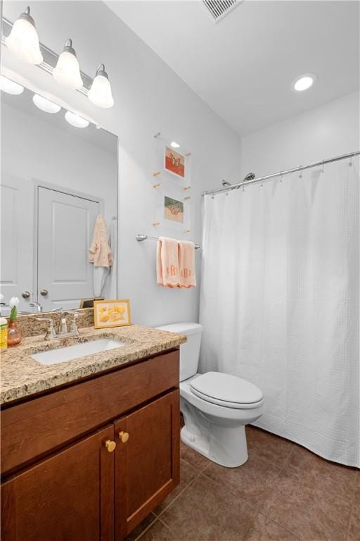 bathroom with vanity, toilet, visible vents, and tile patterned floors