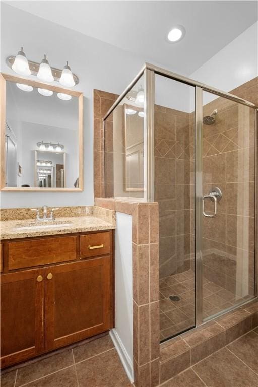 bathroom with vanity, a shower stall, and tile patterned floors