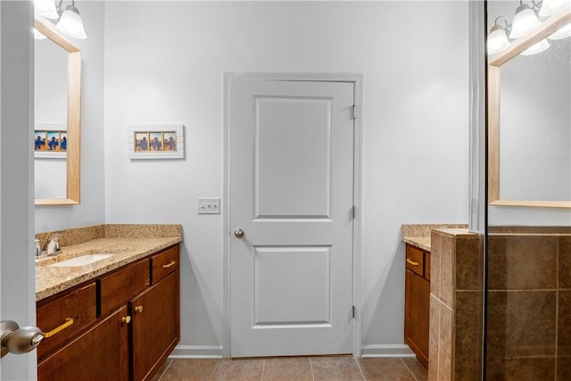 bathroom featuring vanity, baseboards, and tile patterned flooring