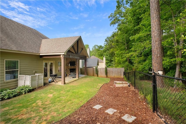 view of yard featuring a patio, french doors, and a fenced backyard