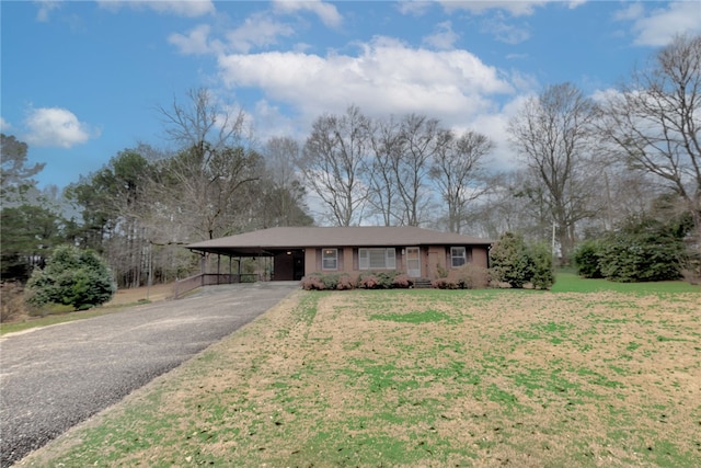 ranch-style house featuring a carport and a front lawn