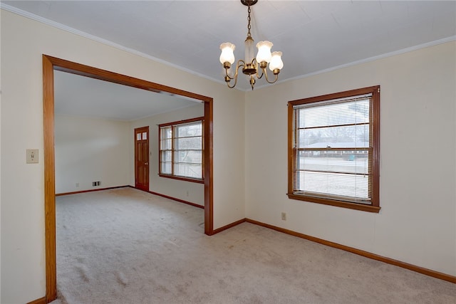 empty room featuring light carpet, crown molding, and a chandelier