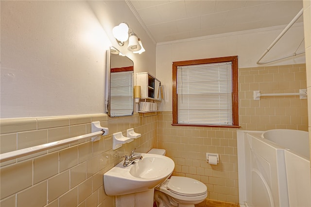 bathroom featuring sink, tile walls, a washtub, toilet, and crown molding