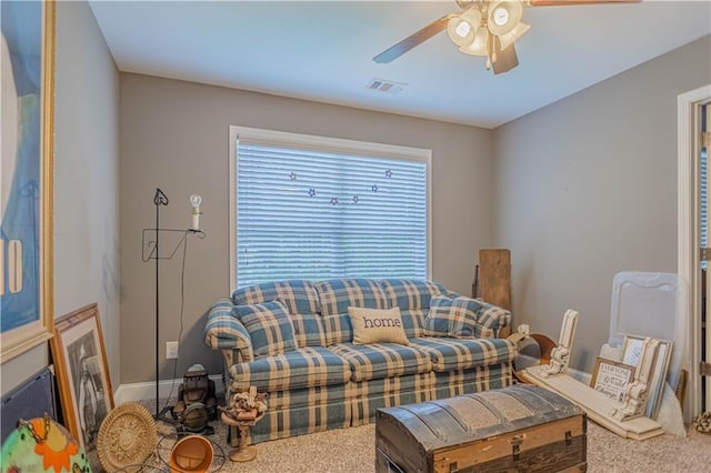 carpeted living room with ceiling fan