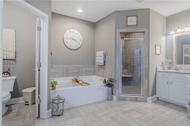 full bathroom featuring tile patterned floors, vanity, shower with separate bathtub, and toilet