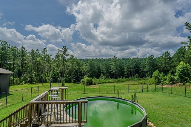 view of swimming pool featuring a yard