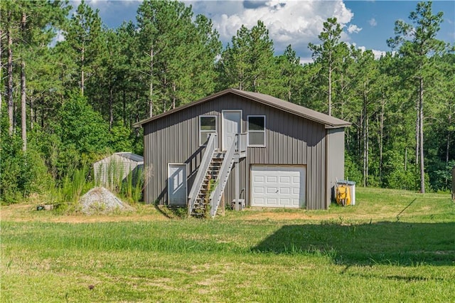 view of outdoor structure featuring a yard and a garage