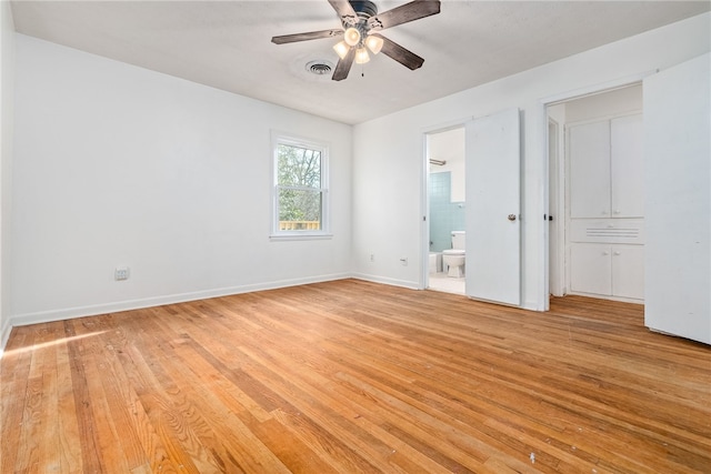 unfurnished bedroom featuring ensuite bath, light hardwood / wood-style floors, and ceiling fan