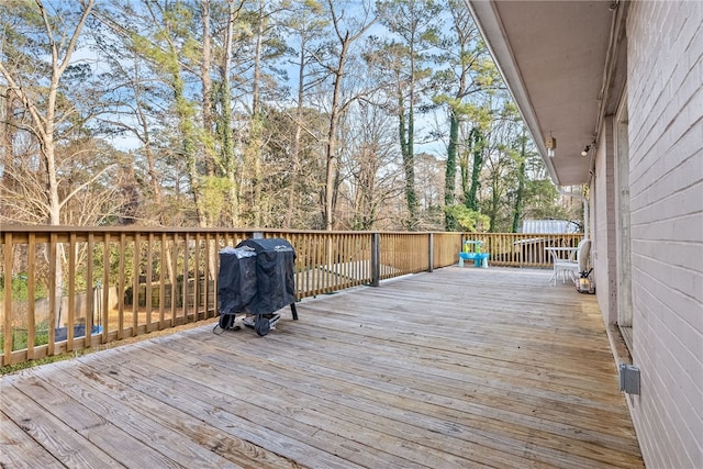 wooden terrace featuring grilling area