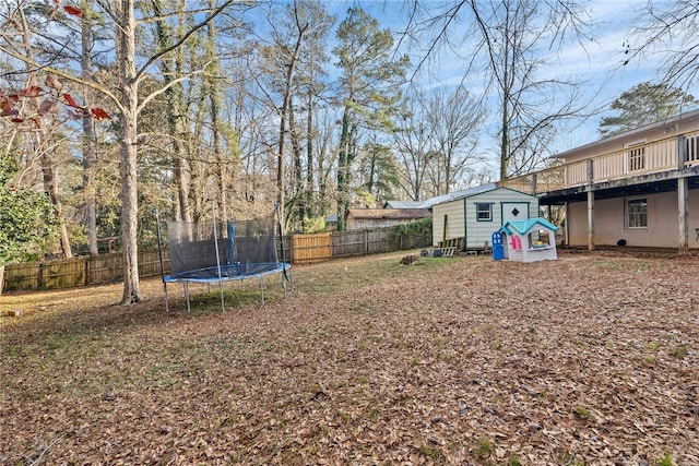 view of yard featuring a shed and a trampoline