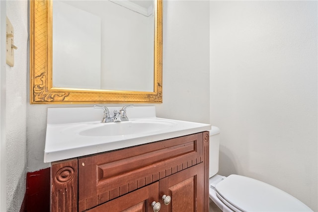 bathroom featuring vanity, ornamental molding, and toilet