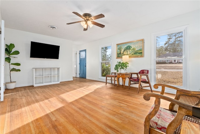 living area featuring ceiling fan and light hardwood / wood-style floors