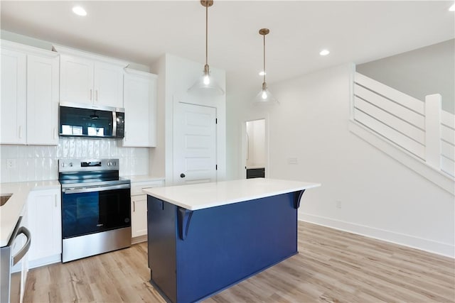 0309 Northgate Blvd, Auburn, AL 36830 - kitchen featuring stainless steel appliances, light wood-style floors, a center island, tasteful backsplash, and light countertops