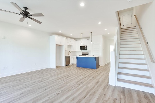 0309 Northgate Blvd, Auburn, AL 36830 - unfurnished living room with light wood-type flooring, recessed lighting, stairway, and ceiling fan