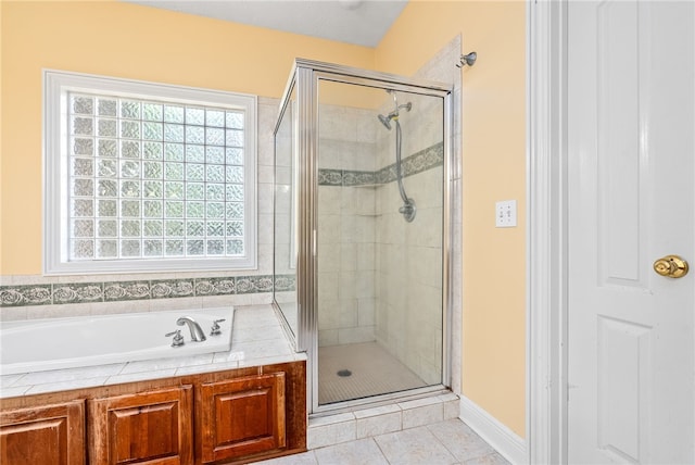 full bath with a garden tub, tile patterned flooring, and a stall shower