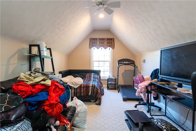 carpeted bedroom with a textured ceiling, ceiling fan, and lofted ceiling