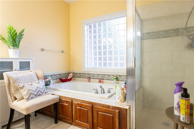 bathroom featuring tile patterned floors and separate shower and tub