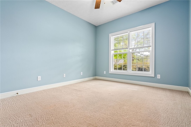 spare room featuring baseboards, ceiling fan, and light colored carpet