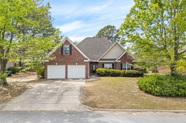 view of front of home featuring brick siding, an attached garage, a front lawn, and concrete driveway