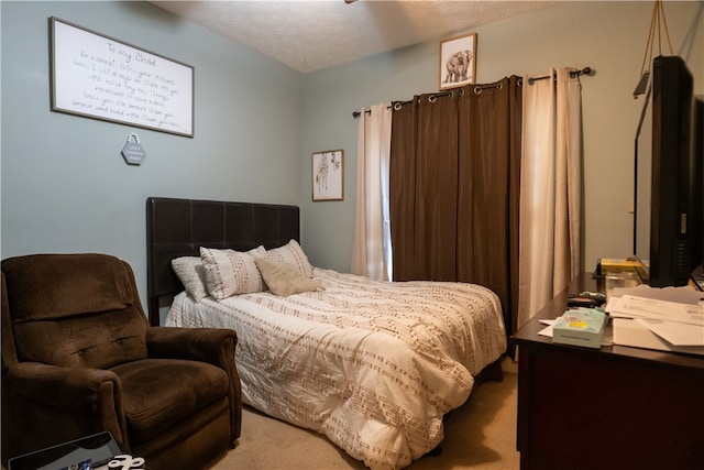 bedroom featuring carpet floors and a textured ceiling