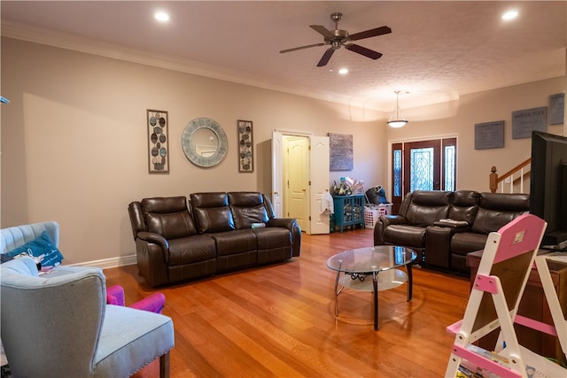 living room with ceiling fan, wood-type flooring, and crown molding